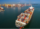 aerial-front-smart-cargo-ship-carrying-container-running-near-international-custom-sea-port-export-cargo (1)
